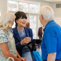 President Mantella speaking with two event attendees